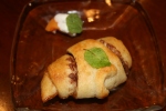 This is the second group's dessert: a chocolate filled crescent roll with a fresh apricot garnished with whipped cream and mint